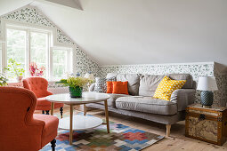 Cosy, attic living room with upholstered furniture
