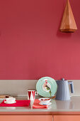 Kitchen worktop against red wall