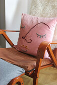 DIY cushion cover with line art on armchair