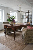 Rustic dining table with rattan chairs in open plan living area