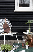 Metal chair and wooden block used as side table on terrace