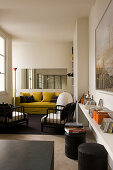 Open living room with yellow couch in a 1-room flat