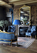 Antique furniture in salon sitting room in masculine shades of blue and brown