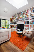 Floor-to-ceiling bookcase in interior with skylight