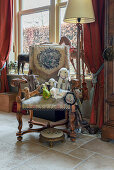 Vintage-style soft toys on antique armchair in living room decorated with flea-market finds