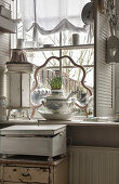 French atmosphere with old soup tureen on windowsill in the kitchen
