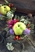 Flower arrangement with apple in a flower pot