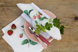 DIY fabric napkins with strawberry motif on garden table