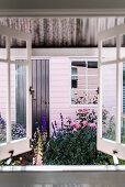 A view to the potting shed in the garden, with the door painted