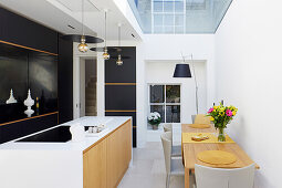 Modern open kitchen with skylight and dining table