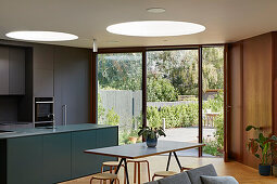 Open plan kitchen and living area with circular roof lights