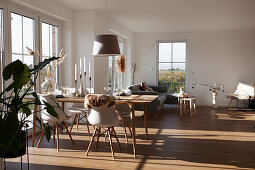 Dining area with classic chairs in a bright, sunlit open living room