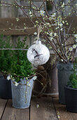 Plum blossom twigs with Christmas ornament and a pine tree