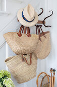 Sea grass bags and hat on white staircase wall