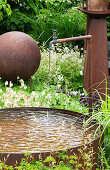 Garden fountain with rusty basin