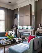 Light blue day beds, marble fireplace, concealed television above
