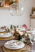 Christmas table with raffia placemat and white plates