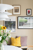 Picture wall in the dining area, designer pendant light in the foreground