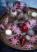 Red and white star-shaped fairy lights and Christmas tree baubles