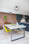 Custom concrete table with classic chairs in open kitchen