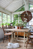 Rustic table with chairs in the orangery, built from recycled window frames