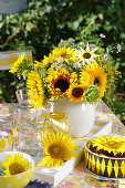 Bouquet of sunflowers on outdoor table with sunflower cake