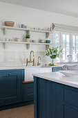White kitchen with blue cabinet fronts