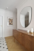 Sideboard, above mirror on wall with elegant stucco work