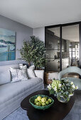Elegant living room in grey tones, dark coffee table