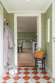 Hallway with checkered wooden floor and green wallpaper