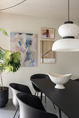 Black table, pendant lamp above in the dining room