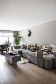 Grey sofa set with throw pillows and coffee table in light living room