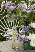 Table decorated with lilacs in the garden