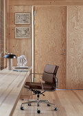 Integrated built in desk with leather chair in room with wooden elements