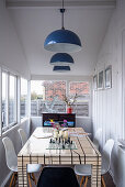 Dining area with pendant lights with chess board set up on the table