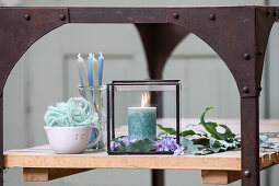 Candle and hyacinth flowers in a glass cube