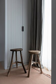 Changing room with built-in wardrobe, wooden stool in front of window