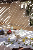 Set table on terrace with sunshade
