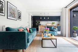 Blue upholstered furniture and coffee table in open-plan living room in front of terrace access