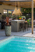 Wooden terrace with outdoor kitchen and pool