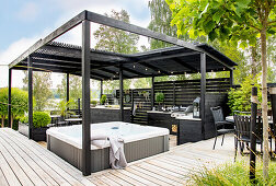Modern garden pavilion with whirlpool and outdoor kitchen