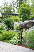 Garden with large stones and a variety of plants