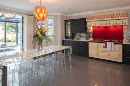 Open-plan kitchen and dining area with a view of the conservatory