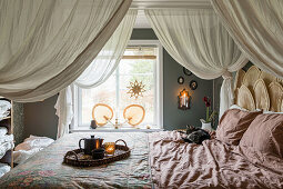 Cozy boho-style bedroom with decorative textiles
