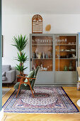 Living room with oriental rug and display cabinet
