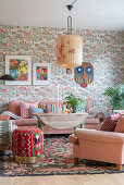 Living room with pink upholstered furniture and vintage wallpaper