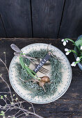 Place setting with place cards and wreath of cypress, snowdrops