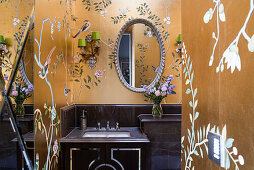 Bathroom with Chinoiserie de Gournay wallpaper and oval mirror