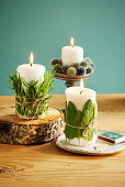 Decorative pillar candles wrapped with rosemary, sage and thistle balls