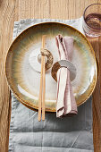 DIY napkin ring made from papier-mâché for an Asian table setting